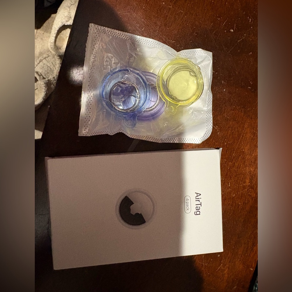 Apple AirTag with Blue and Yellow Cases